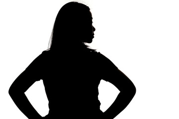 Black backlit silhouette of head and shoulders of an oriental woman from back view outlined by light