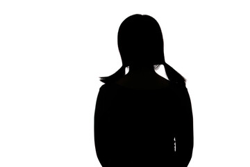 Black backlit silhouette of head and shoulders of an oriental woman from back view outlined by light