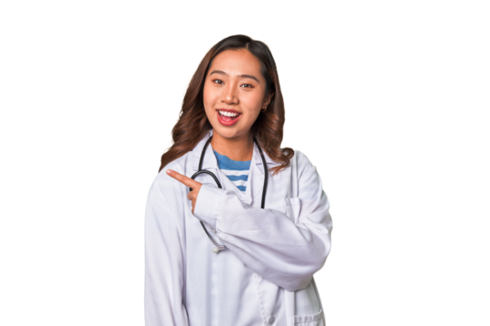 A young asian doctor woman smiling and pointing aside, showing something at blank space.