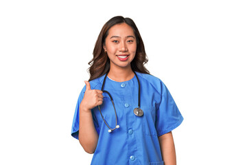 A young nurse chinese woman smiling and raising thumb up