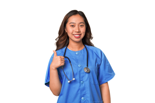 A young nurse chinese woman smiling and raising thumb up