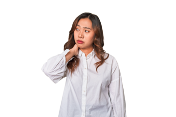 A young chinese woman touching back of head, thinking and making a choice.