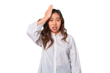 A young chinese woman forgetting something, slapping forehead with palm and closing eyes.