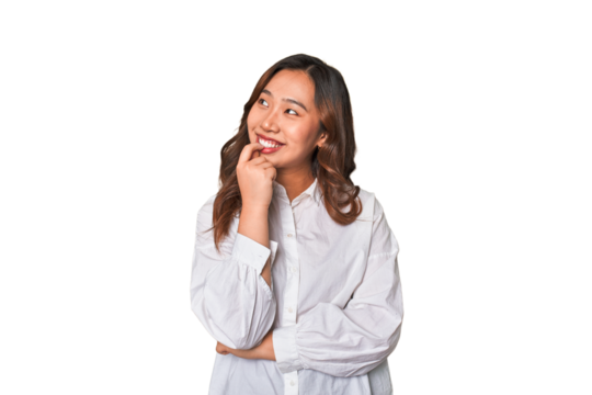 A young chinese woman relaxed thinking about something looking at a copy space.