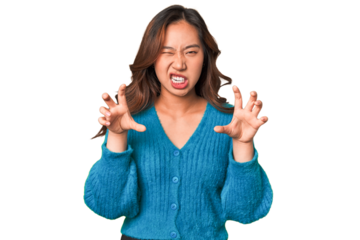 A young chinese woman showing claws imitating a cat, aggressive gesture.