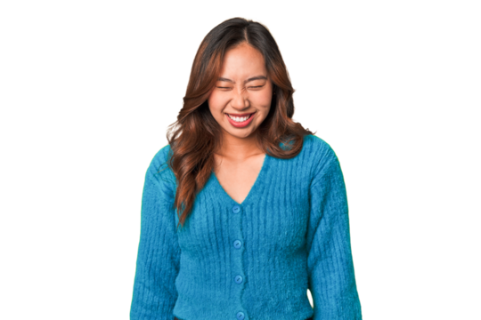 A young chinese woman laughs and closes eyes, feels relaxed and happy.