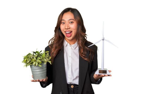 A powerful Chinese businesswoman holds a thriving plant and a windmill model, symbolizing her commitment to sustainable and responsible business practices.