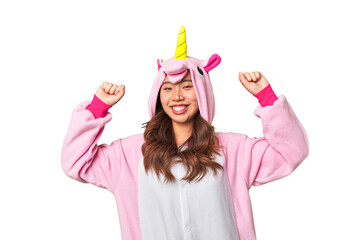 Young chinese woman in an unicorn costume very happy © Asier