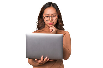 A young asian woman working with her laptop thinking about an idea