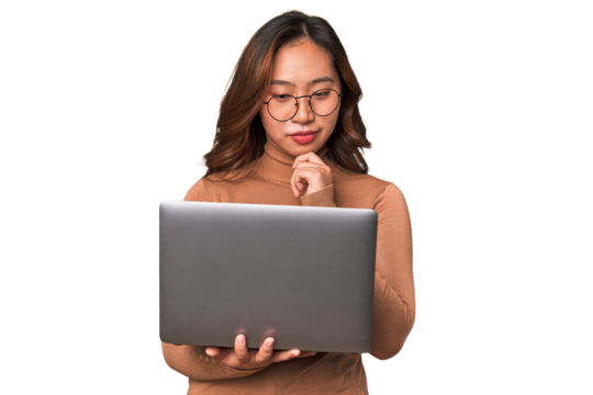 A young asian woman working with her laptop thinking about an idea