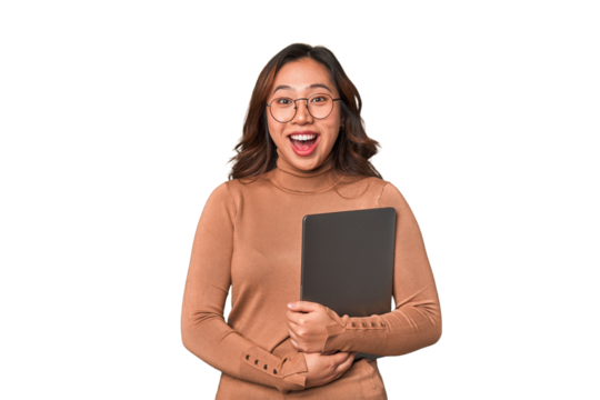 A young asian woman being suprised by a new while she is working with her laptop