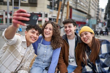 Friends taking selfie on a bench in Spain.