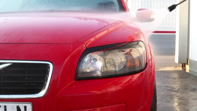 Man washing a car with high pressure water Cleaner