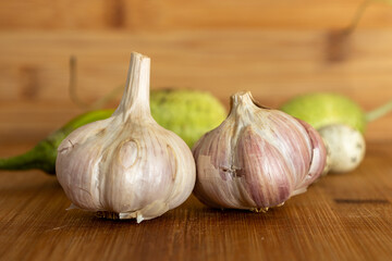 Vegetables from the garden on a wooden table forming a still life of vegetables and greens.