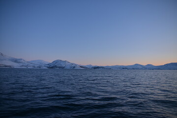 Mountains in the northern part of Norway, at the outlet to the ocean. Incredible sunset