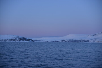 Mountains in the northern part of Norway, at the outlet to the ocean. Incredible sunset