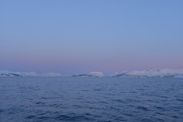 Mountains in the northern part of Norway, at the outlet to the ocean. Incredible sunset