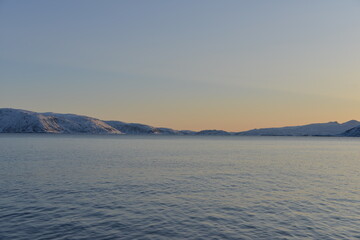 Mountains in the northern part of Norway, at the outlet to the ocean. Incredible sunset