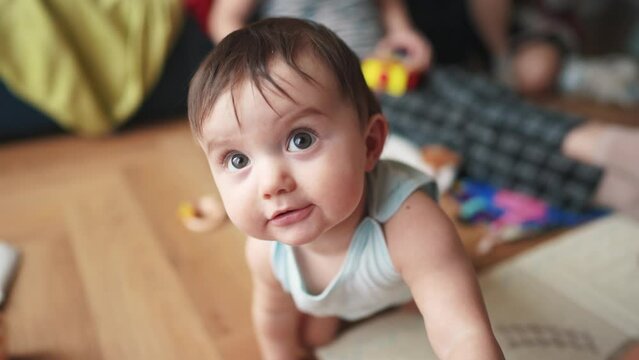 baby smiles at the camera and plays. happy family kid dream concept. baby trying to hug the camera smiling playing close-up. baby stretches his hand smiling looks at the camera big lifestyle eyes