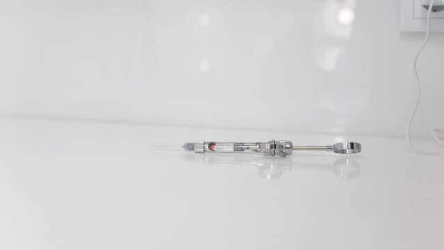 female hand takes a carpool syringe from a white background nurse anesthetist doctor Surgeon doctor preparing injection carpulse syringe