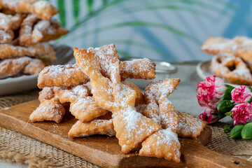 Traditional Italian carnival fritters dusted with icing sugar - frappe or chiacchiere
