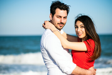 Romantic couple hugging on the beach