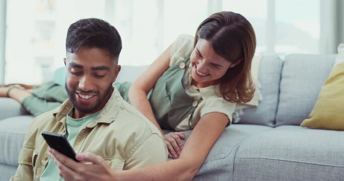 Phone, comic and happy couple relax on a sofa, laughing and sharing social media meme in their home. Funny, joke and man with woman checking smartphone for silly text, app or message in a living room