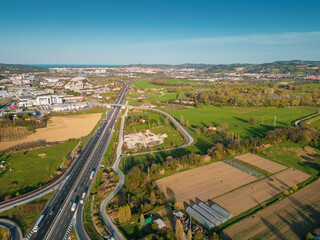 Fototapeta premium Aerial view over highway with moderate traffic and toll booth