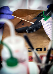 Police scientist analyzes gunpowder evidence with isopo in crime lab, conceptual image