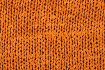yellow unusual texture.knitted orange sweater close up. handmade concept
