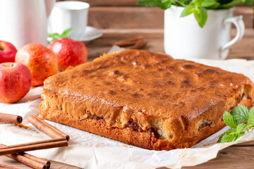 Clasic sponge cake with apples on table, selective focus. Homemade cake