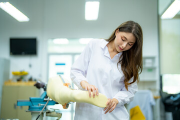 Fototapeta premium Orthopedic technician adjusting prosthetic leg for disabilities people