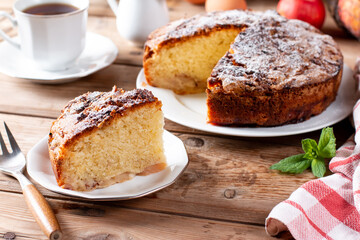 Clasic sponge cake with apples on table, selective focus. Homemade cake