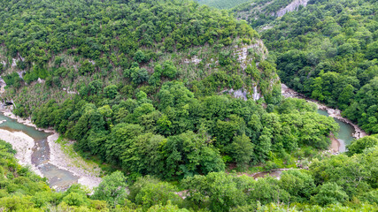 Fototapeta na wymiar Ckalcitela (Tskaltsitela) river gorge (Red Water, Red River) at the foot of the Motsameta monastery, a tributary of the Rioni river, among green lush forests, Imereti Region, Georgia.