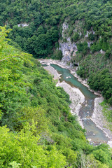 Fototapeta na wymiar Ckalcitela (Tskaltsitela) river gorge (Red Water, Red River) at the foot of the Motsameta monastery, a tributary of the Rioni river, among green lush forests, Imereti Region, Georgia.