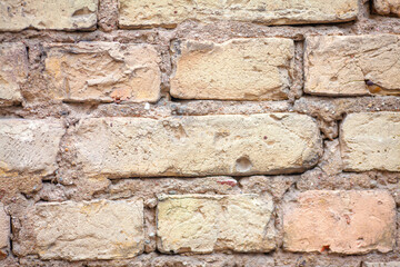 Yellow brick wall, old brickwork with cement