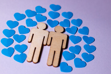 Male love LGBT. Same-sex family icons. gay couple of two homosexual men. The male couple is holding hands. Wooden people with paper blue hearts