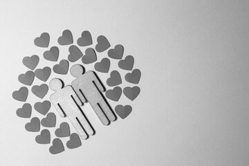 Male love LGBT. Same-sex family icons. gay couple of two homosexual men. The male couple is holding hands. Wooden people with paper blue hearts