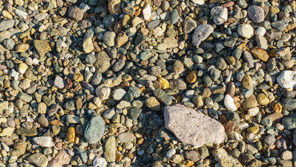 Various stones top view on the beach. 