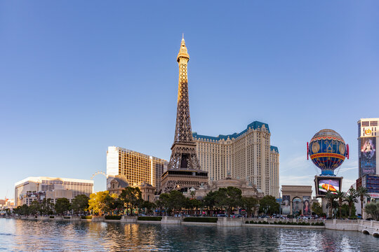 Las Vegas, United States - November 23, 2022: A picture of the Eiffel Tower and Balloon Sign of Paris Las Vegas, with the main building in the back and the Bellagio Fountain on the foreground.