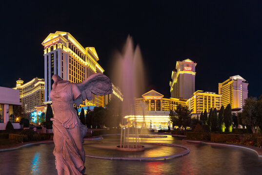 Las Vegas, United States - November 23, 2022: A picture of the Caesars Palace at night as seen from its fountains, with the Nike of Samothrace statue on the left side.