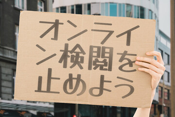 The question " Stop online censorship!" on a banner in men's hands with blurred background. Silence. Regulation. Human rights. Freedom. Free speech. Internet. Network. Violation