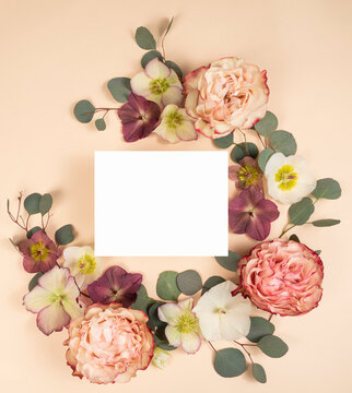 Flat lay with blank stationery invitation card and fresh flowers