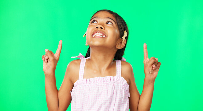 Face, pointing and black girl with motivation, green screen and inspiration with joy, happiness and space. Portrait, African American female child or young person with gesture for direction or choice