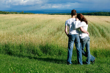 Young Couple Overlooking Farmland Hugging, Ile D'Orleans, Quebec.