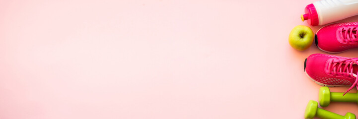 Fitness equipment on pink background, flat lay image.