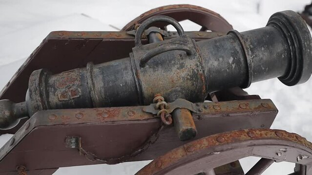 vintage cannon with wheels on the street in winter