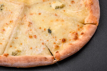 Delicious fresh hot pizza four cheeses cut into pieces