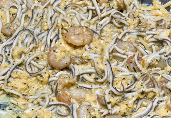 Taste of the sea: Scrambled eggs with prawns and eels