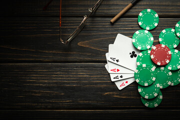 A poker game with a winning combination of four of a kind or quads. Cards with chips on a black...